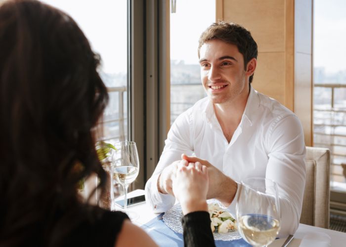 Couple Holding Hands During A Romantic Restaurant Dinner