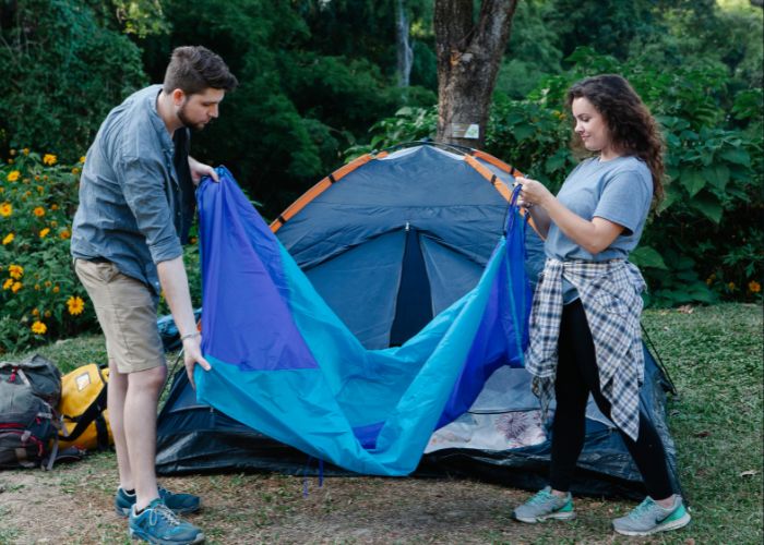 Couple Setting Up A Tent Together