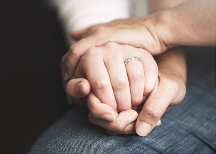 Couple Holding Hands In A Comforting Gesture During An Emotional Conversation.