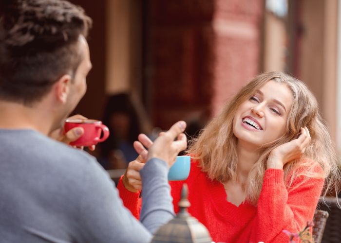 Woman Smiling And Talking During A Casual Coffee Date