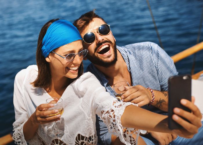 Happy Couple Taking A Selfie On A Sunny Cruise Deck