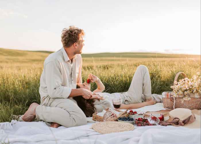 Couple Enjoying A Sunset Picnic