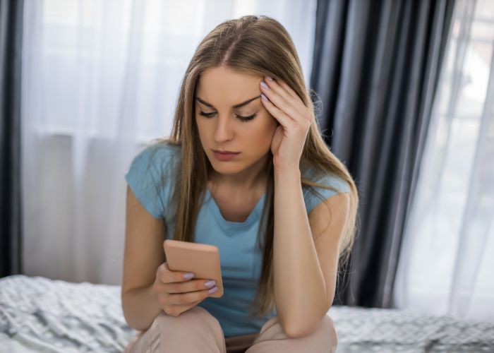 Sad Woman Using Phone