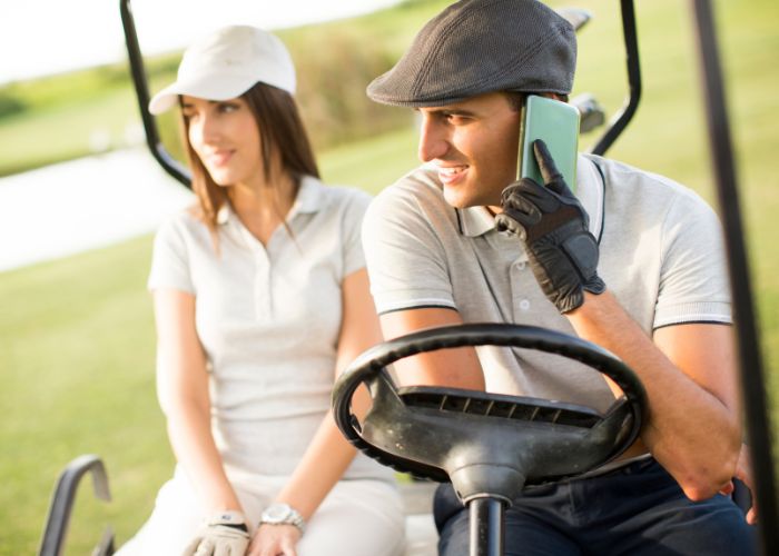Smiling Couple Standing With Golf Clubs During A Relaxed Golf Date