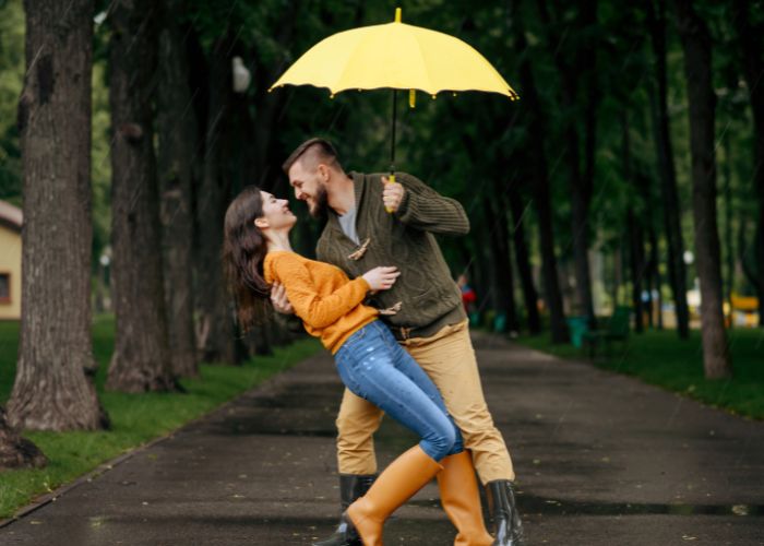 Couple Dancing In Rain With Umbrella