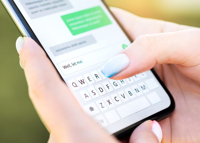Close Up Of A Person Typing A Text Message