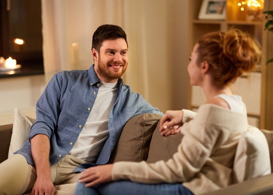Couple Sitting Together And Talking Calmly Indoors