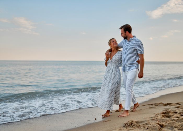 Couple Walking Along The Beach