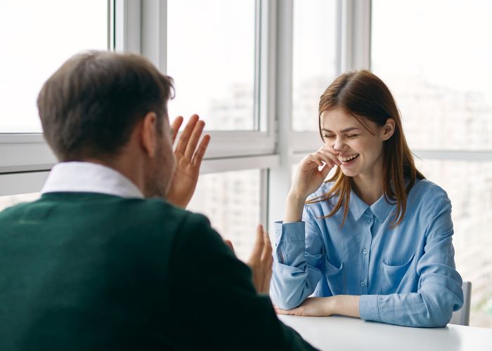 Woman Smiling During A Relationship Compatibility Conversation