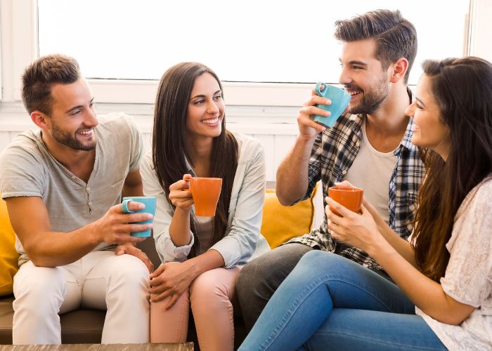 Group Of Friends Chatting And Drinking Coffee Together