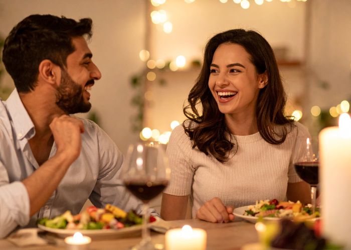 Couple At Home Enjoying Dinner With Wine