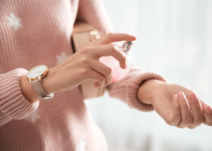 Young Woman Using Perfume