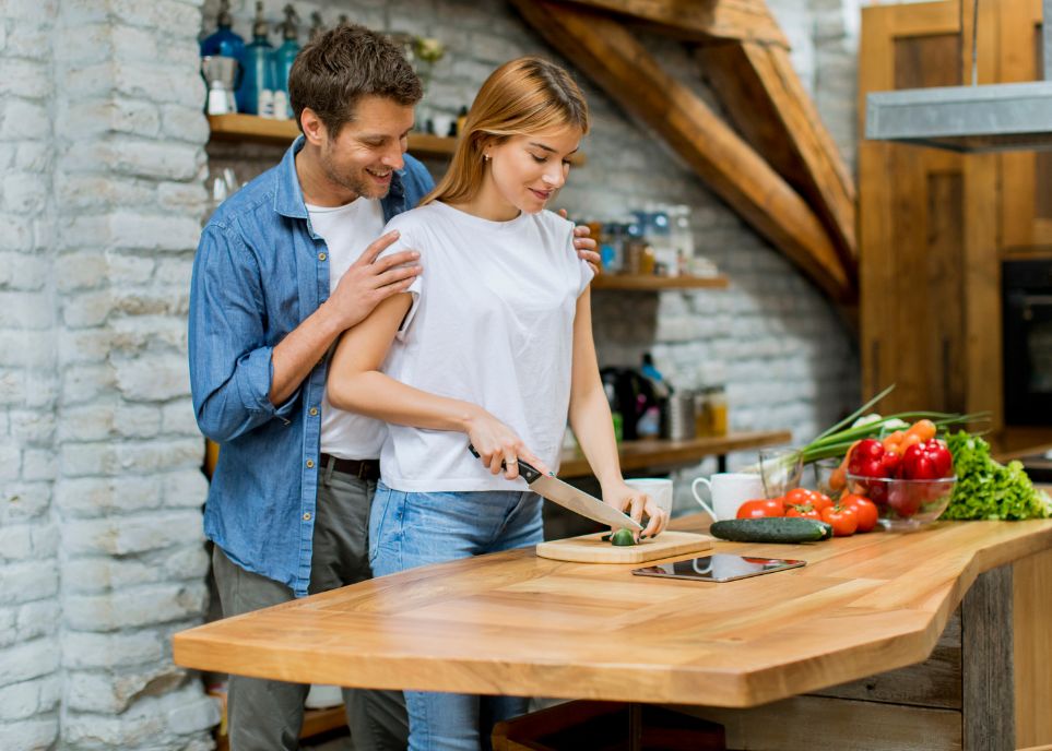 Lovely Cheerful Young Couple Cooking Dinner Together