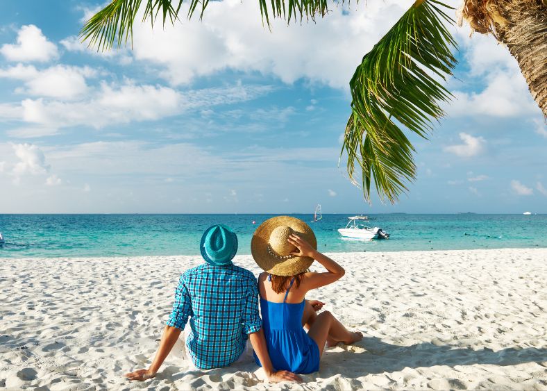 Couple Sitting On Maldives Beach