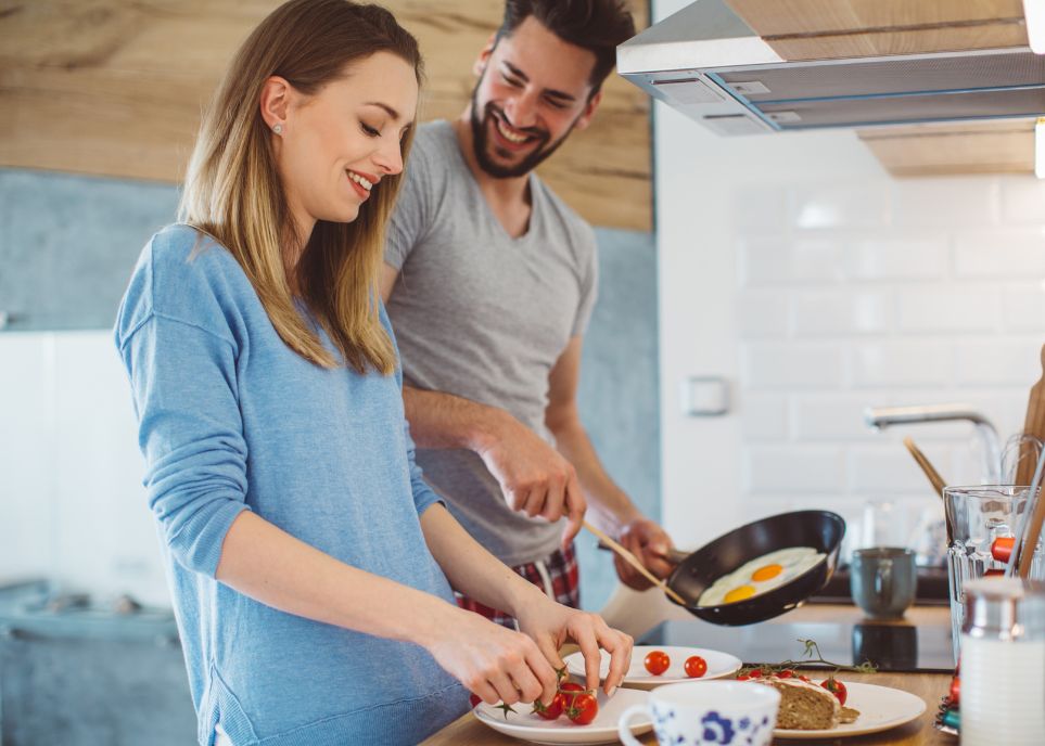 Smiling Couple Preparing Breakfast Together
