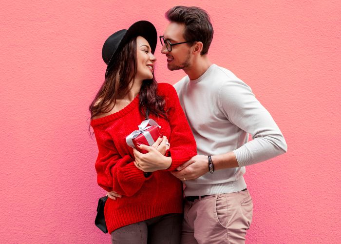 A Man Sharing A Loving Gesture And Giving A Gift To His Girlfriend