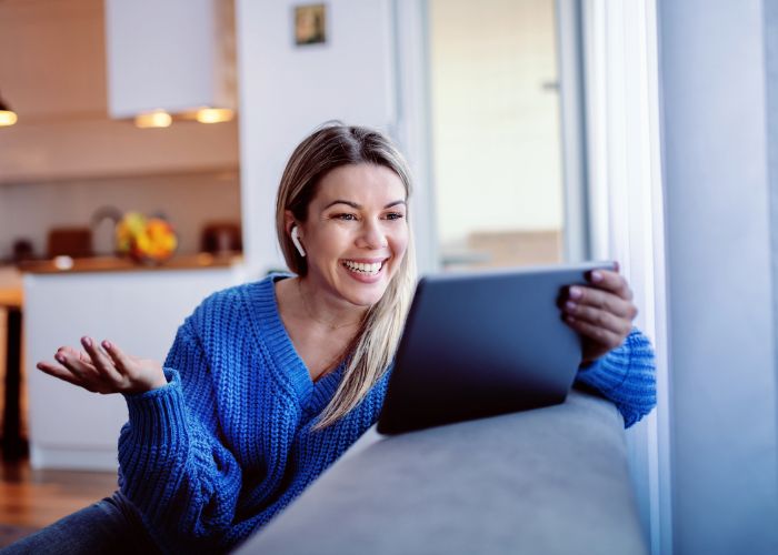 Woman Smiling During A Virtual Scavenger Hunt Video Date With Her Partner