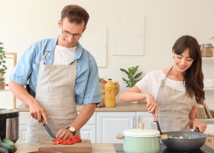 Couple Cooking Together In The Kitchen And Enjoying A Playful Moment