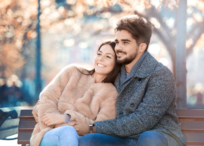 Couple Sit At Bench Outdoor