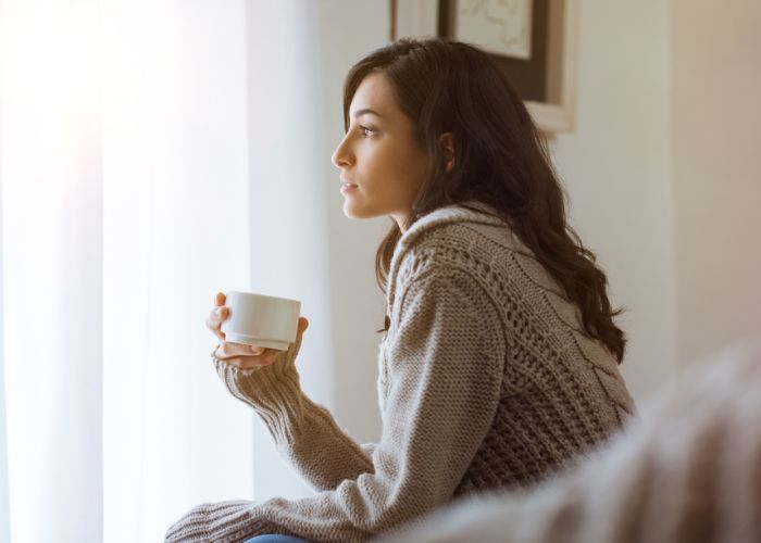 Woman Thinking And Holding Tea Cup