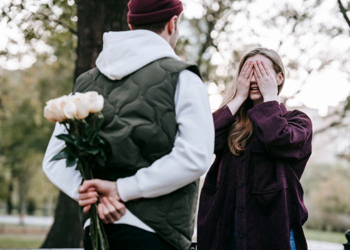 Man Giving Flowers As Present To Girlfriend