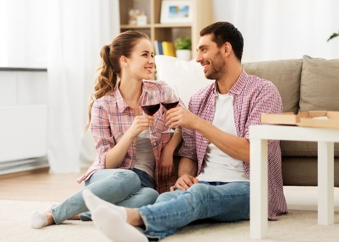 Happy Couple Drinking Red Wine At Home
