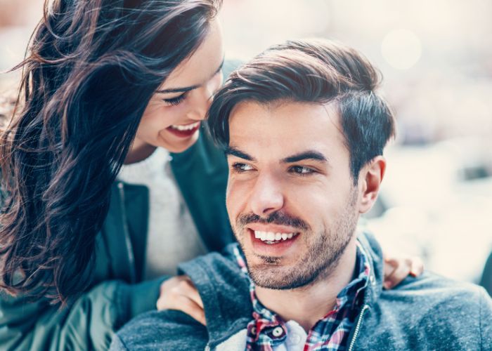 Smiling Woman Leaning Close To A Happy Man