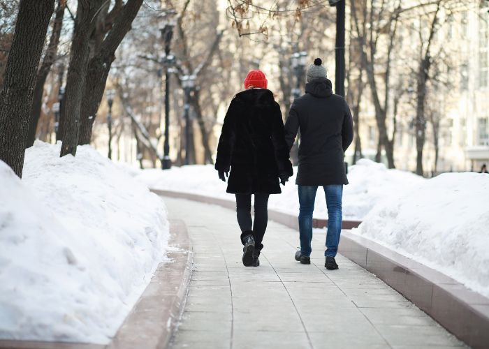 Couple Walking In Snowfall