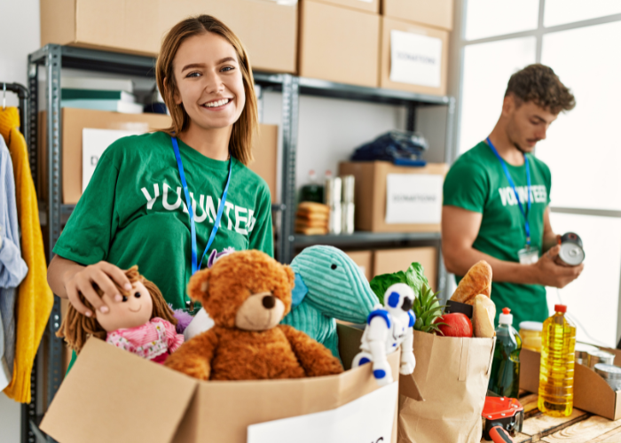 Volunteers Sorting Donated Toys, Food, And Supplies At A Community Center