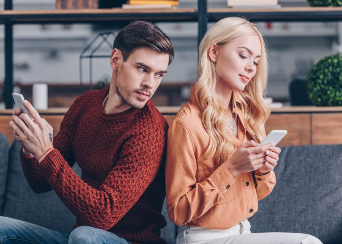 A Man Looking At A Woman's Phone