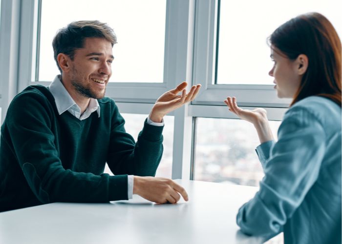 Man And Woman Talking At The Table