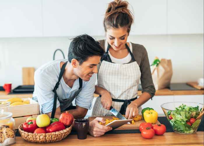 Couple Cooking Together In A Kitchen