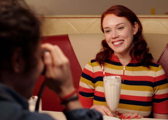 Woman In Front Of A Man At A Cafe