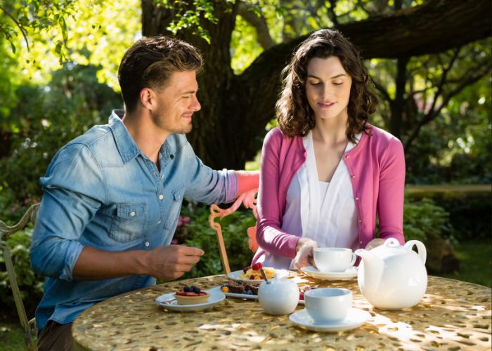 Couple Having Breakfast In Garden