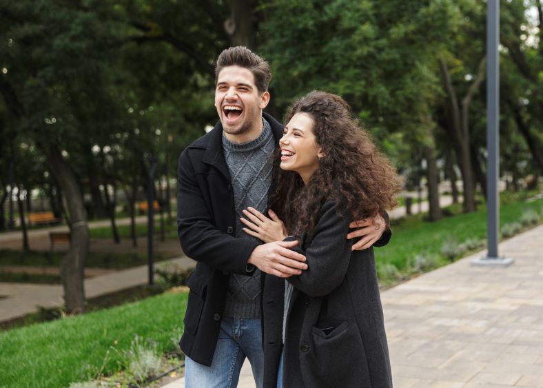 A Happy Couple Walking In The Park