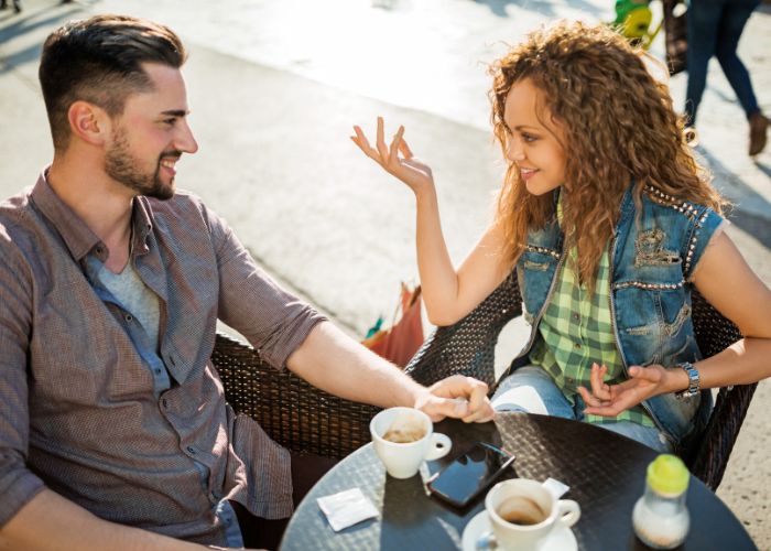 Young Couple Communicating In A Cafe