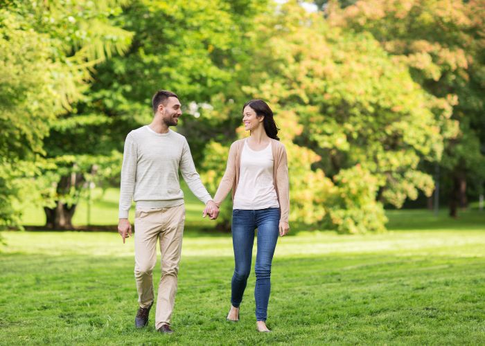 Couple Walking Together In A Park